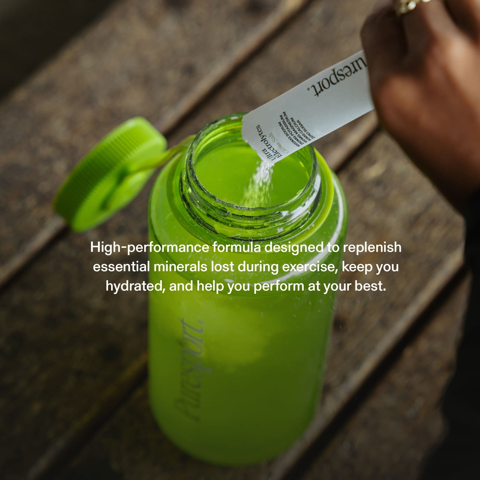 Sports drink bottle with a runner pouring electrolytes by Puresport in it.