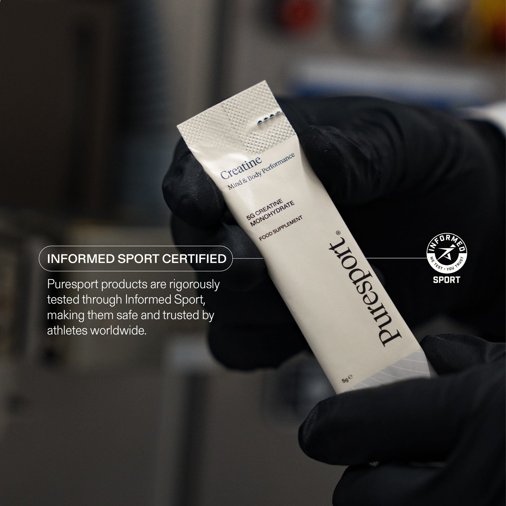 A close up shot of creatine sachet by Puresport with the Informed Sport Certified badge for approval.