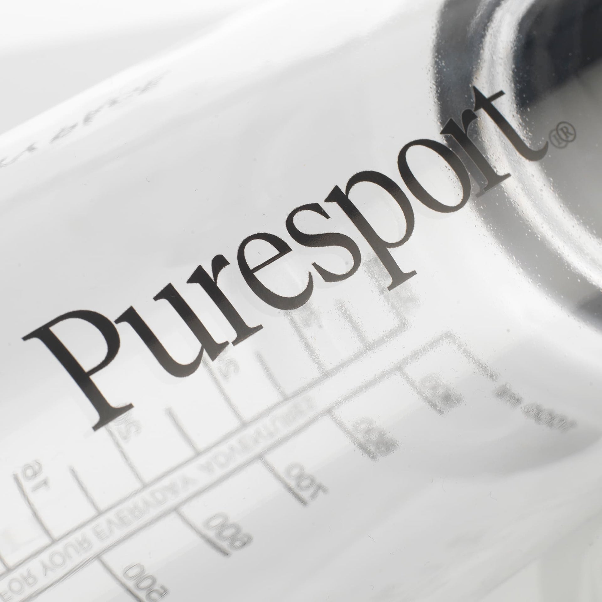 Close-up of a bottle with 'Puresport' branding on a white background