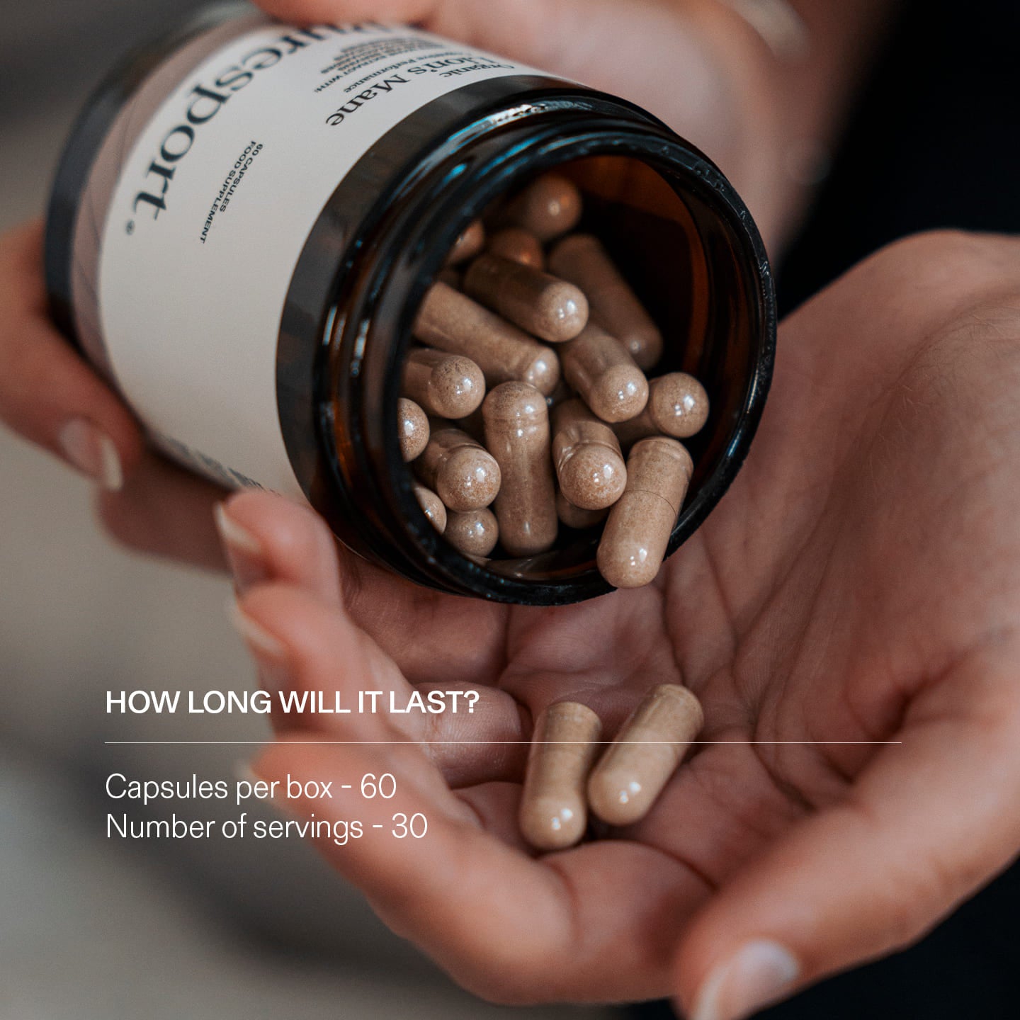 Person holding a jar of capsules of Lions Mane supplements.