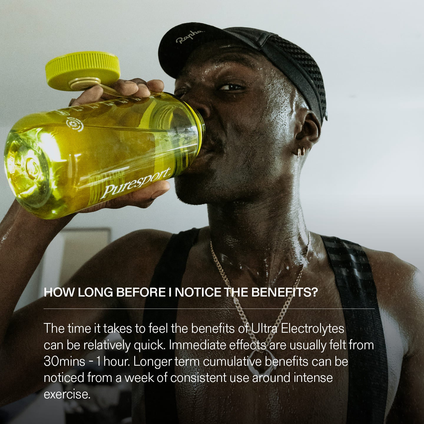 Cyclist drinking from a yellow Puresport bottle with information about electrolyte benefits and why they are good for intense exercise.