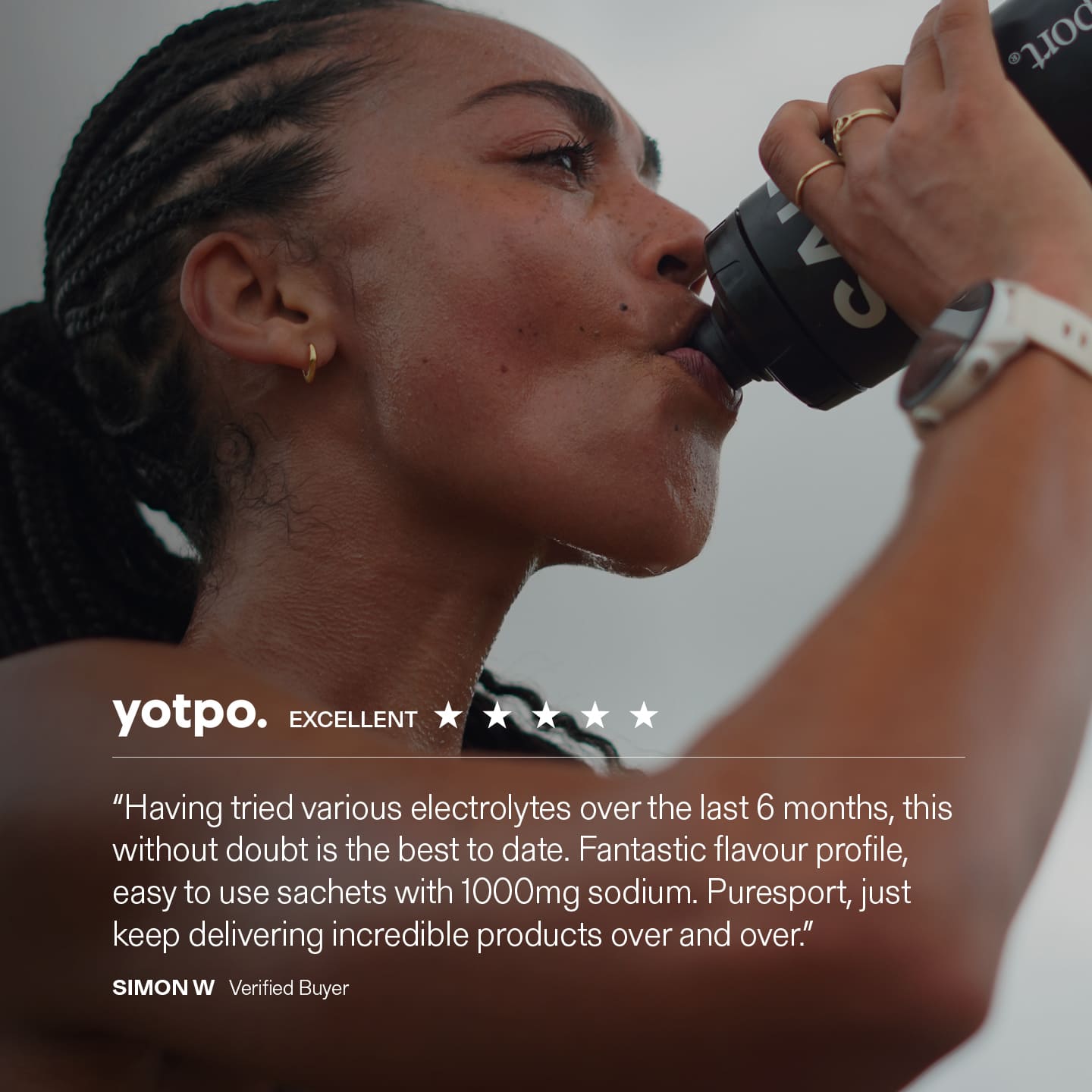 Person drinking from a Puresport bottle with yotpo product with a review quote displayed.
