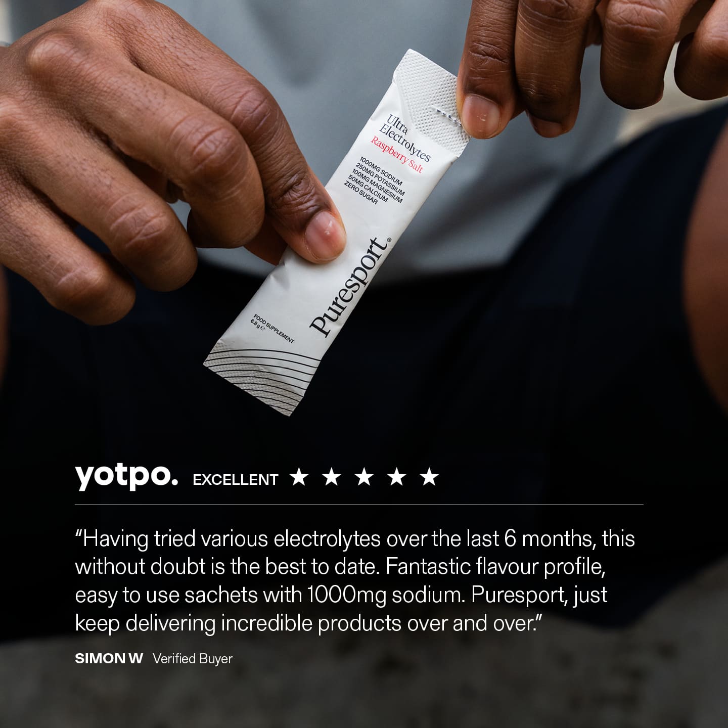 Puresport electrolytes sachet held by a person with a yotpo review displayed below.