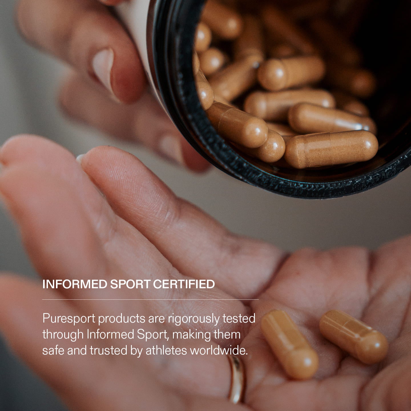 Hand holding capsules of TongKat Ali with a container of capsules, featuring text about Informed Sport Certification.