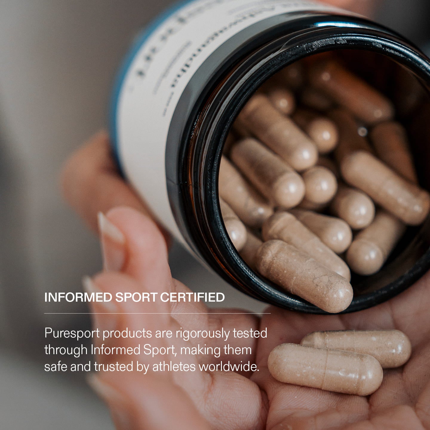 Hand holding a jar of capsules of Ashwanghda  text about Informed Sport Certification.