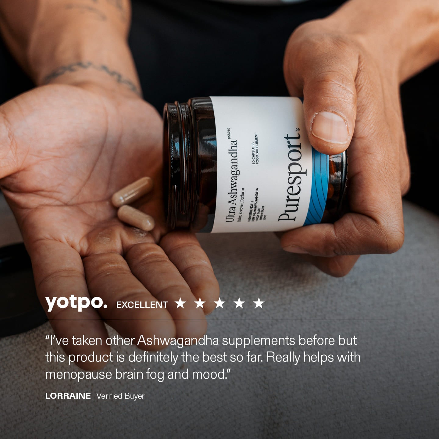 Person holding a jar of Puresport Ashwagandha supplements with a Yotpo review displayed.