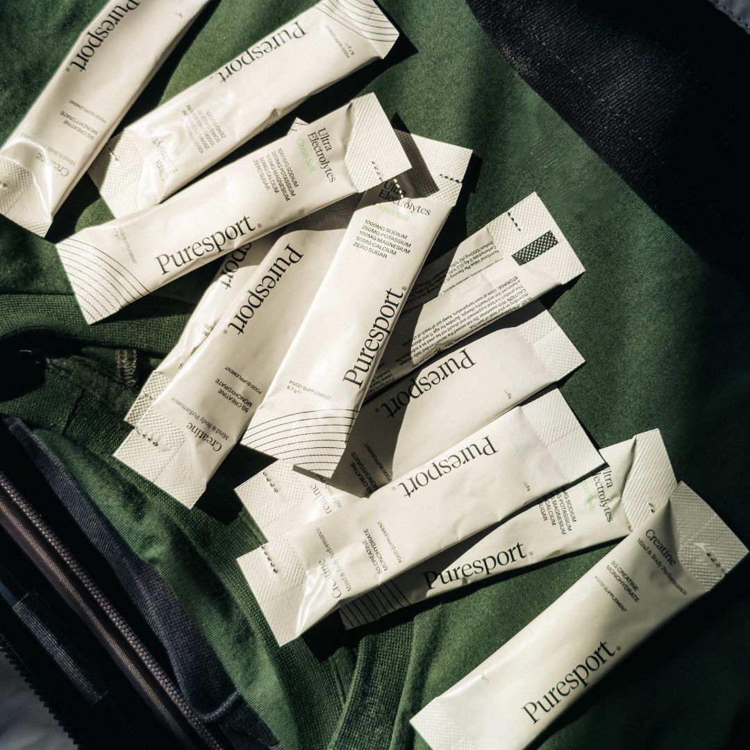 Creatine sachets sprinkled out on athletic top