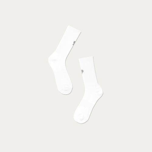 Two white socks collab with 3M and Puresport socks on a light grey background, great for night running. 