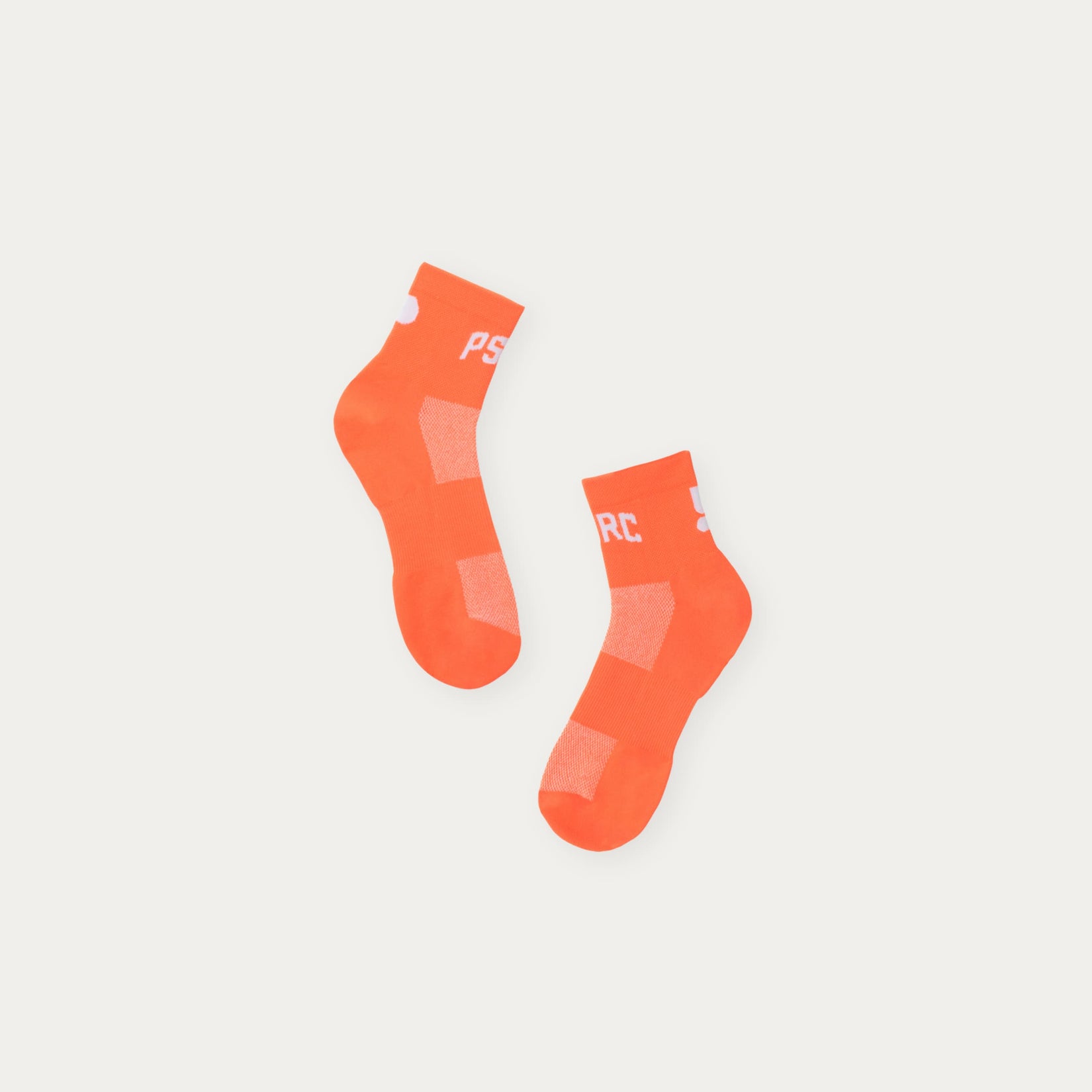 Pair of orange socks with Puresport branding on a light grey background