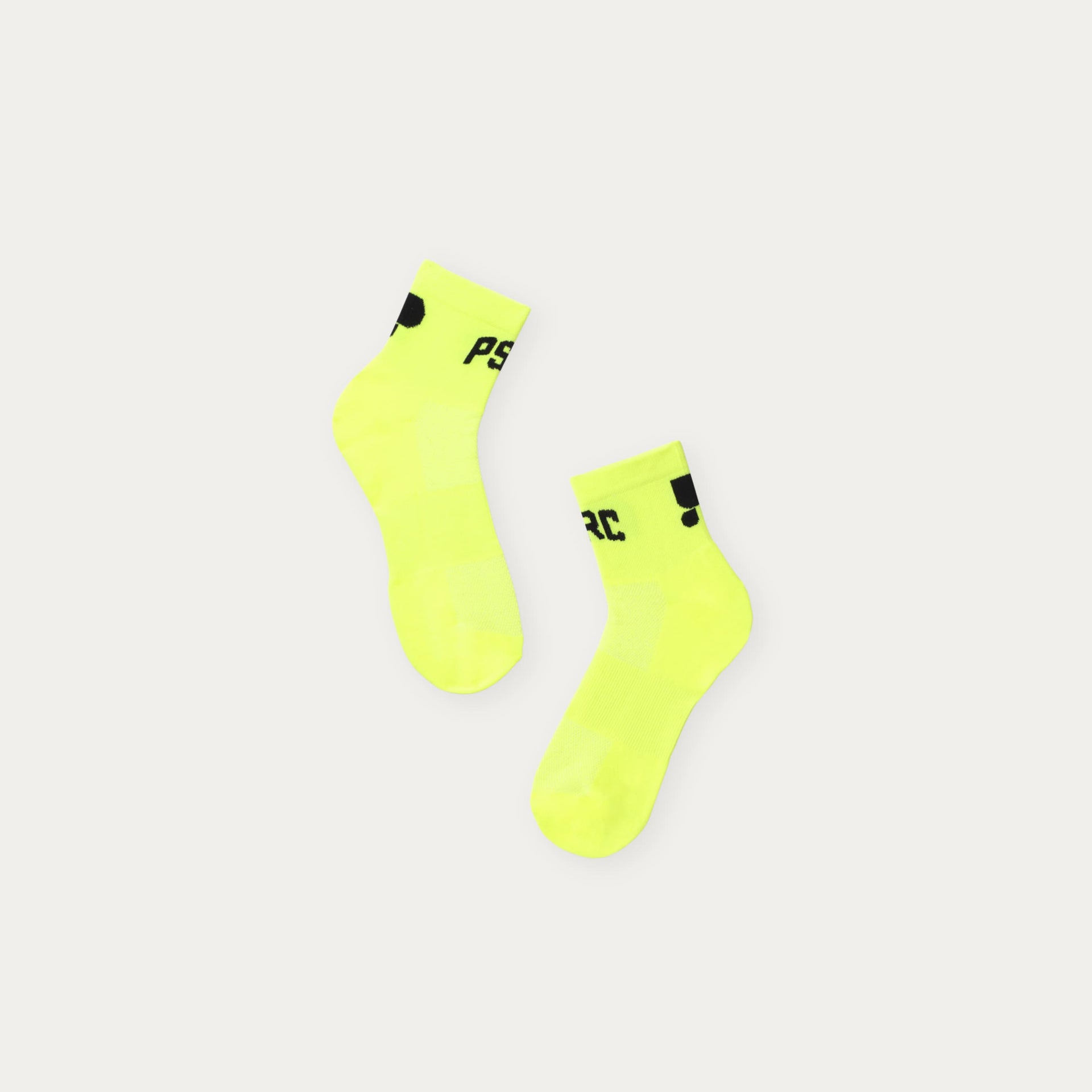 Two neon yellow socks with black Puresport branding on a light grey background