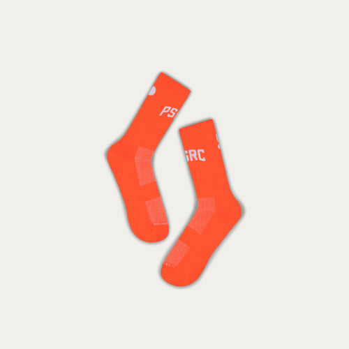 Orange socks with branding on a light gray background