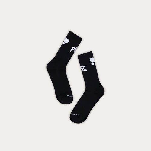 Two black Puresport socks with white branding on a light gray background