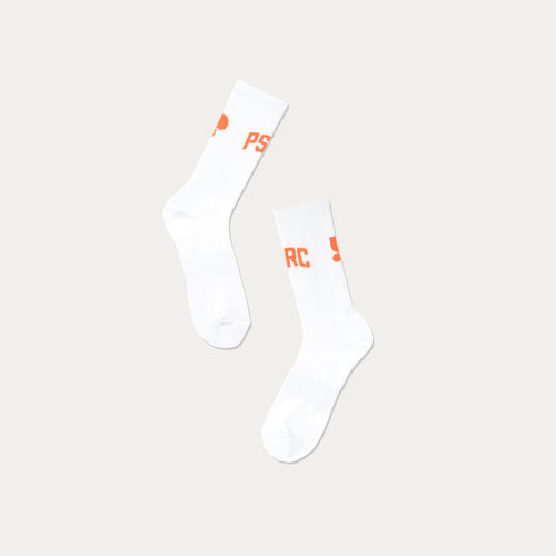 White walking socks with orange Puresport branding on a beige background