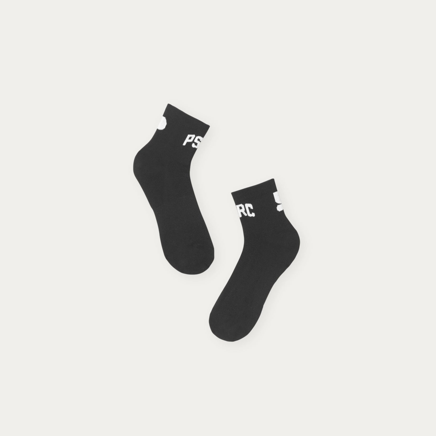 Two black socks with white text on a light gray background