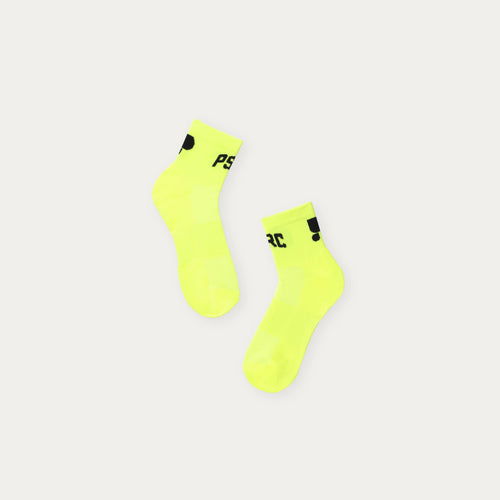 Two neon yellow socks with black puresport branding on a light grey background