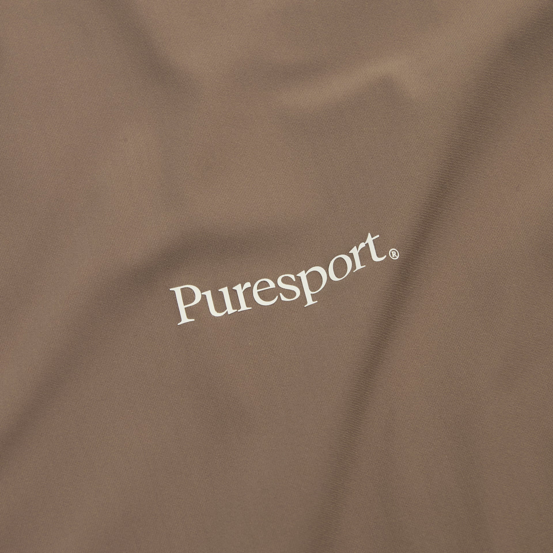 Mocha run fabric with 'Puresport' logo embroidered on it