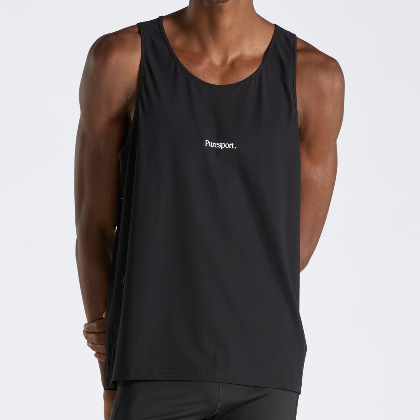 Black run tank top with 'Puresport' logo worn by a person on a white background