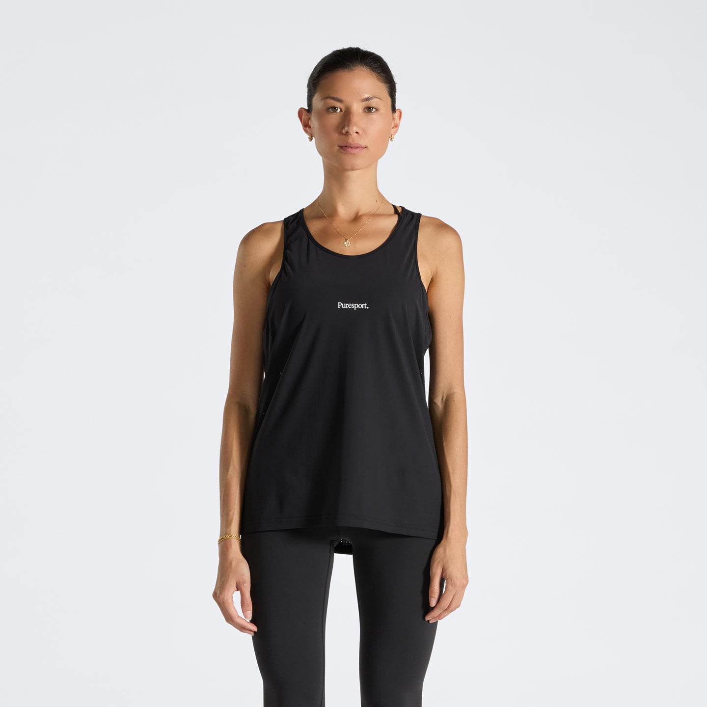 Woman wearing a black run tank top with a Puresport logo on a white background