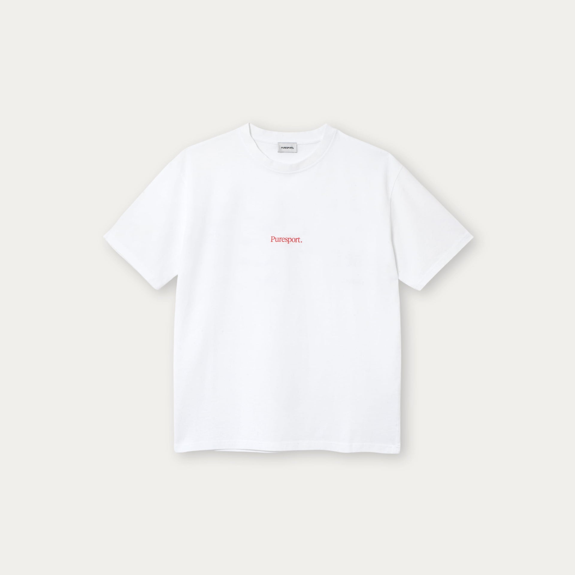 White t-shirt with red text on a light beige background