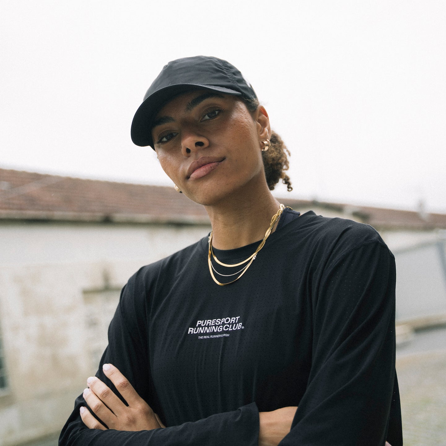 A model in Puresport Clothes with a long sleeve performance top and cap. 