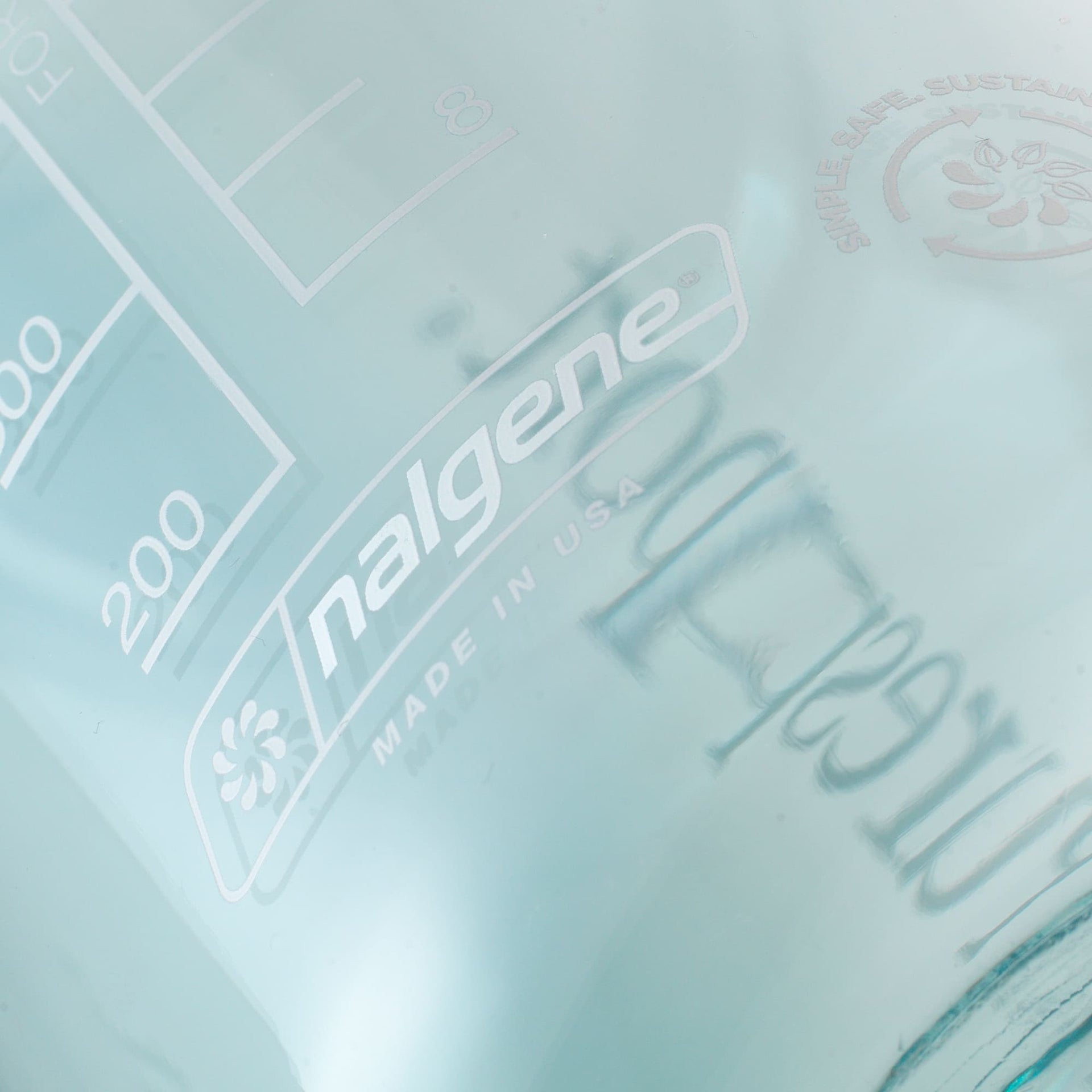 Nalgene water bottle with embossed design and 'Made in USA' text on a light blue background