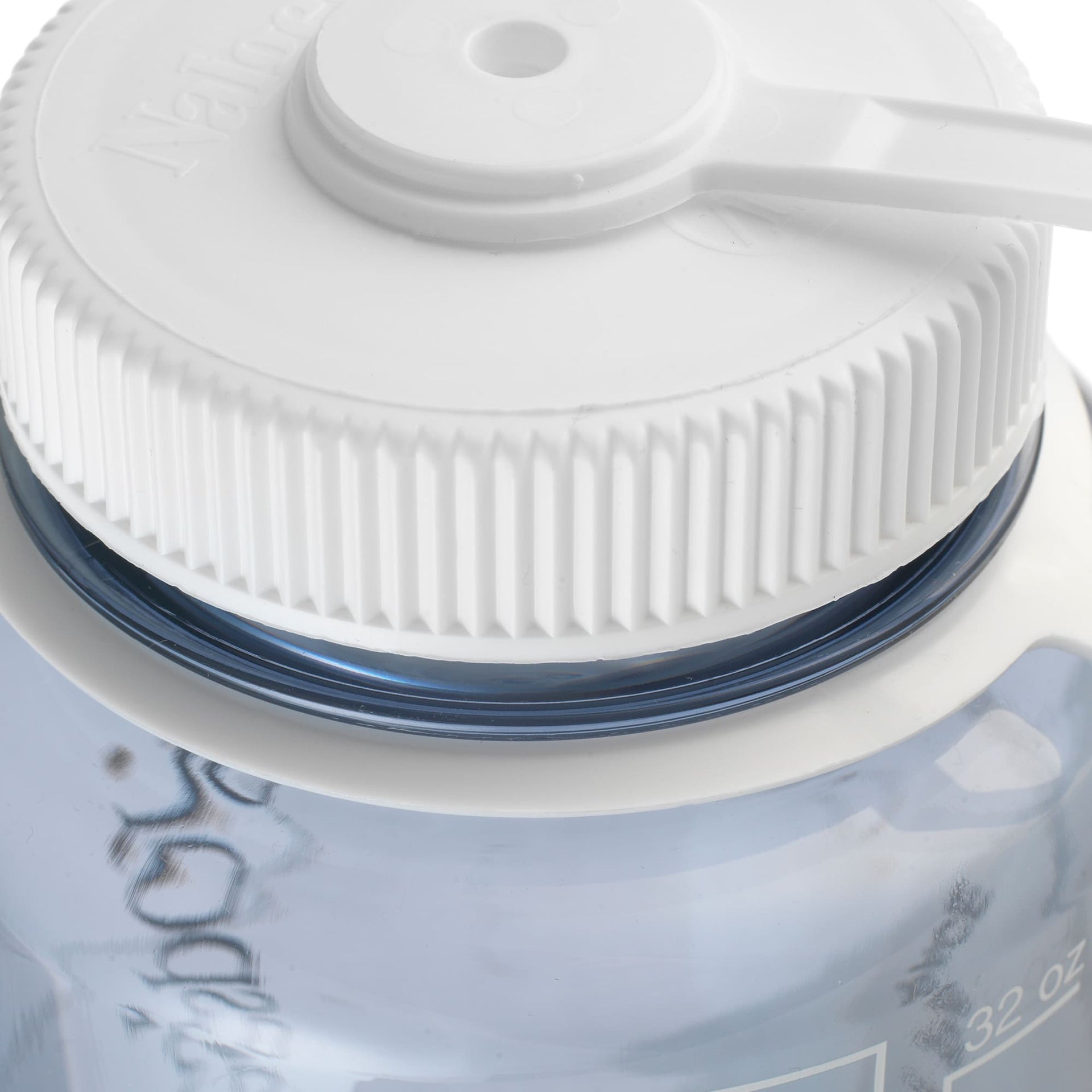 Close-up of a white water bottle cap on a blue water bottle