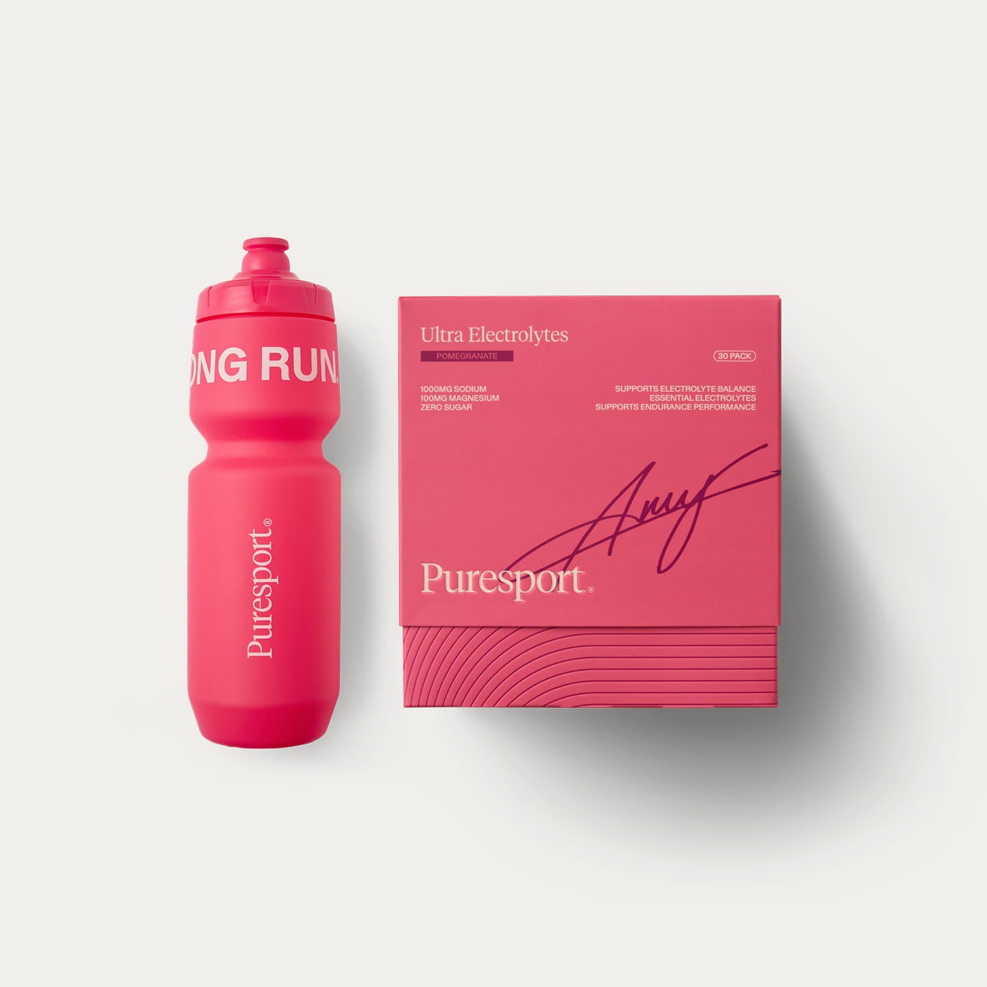A pink Puresport sports bottle next pink packaging Pomegranate electrolytes signature by Amy Hunt.