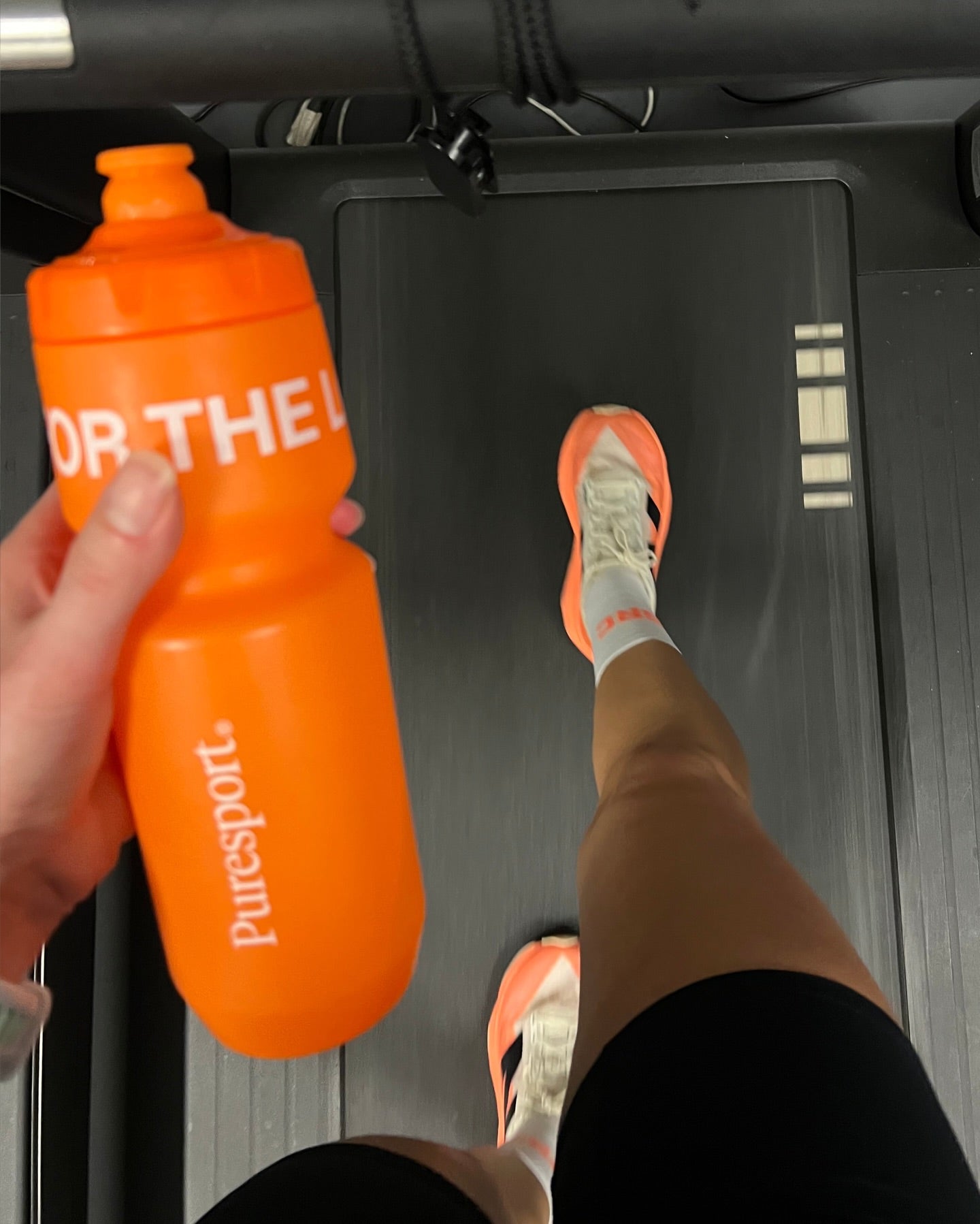 Runner on treadmill with Puresport water bottle