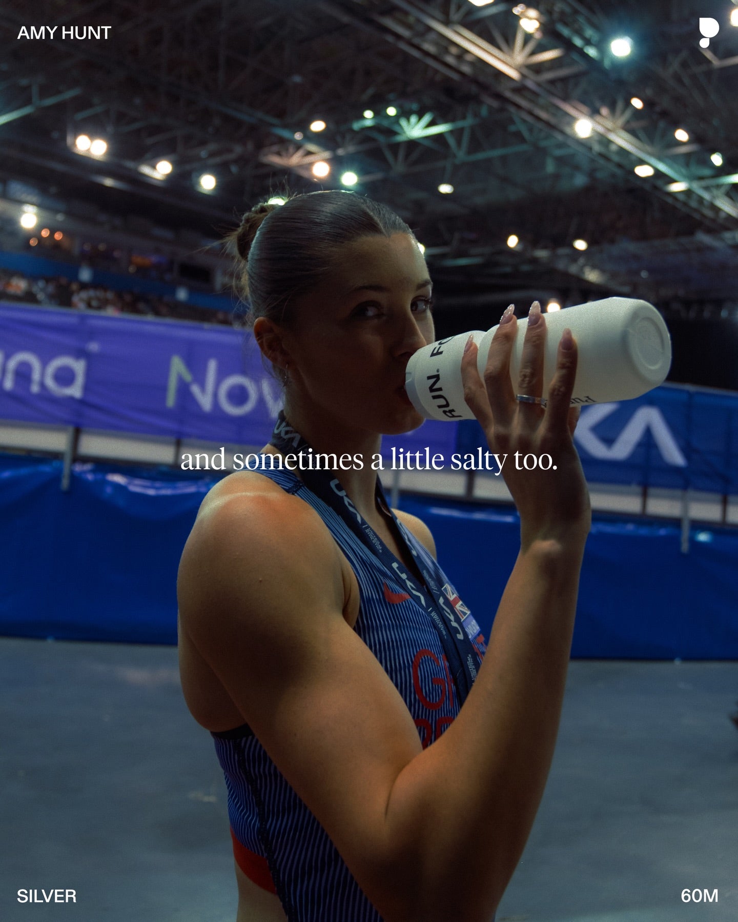 Amy Hunt drinking from a Puresport bottle trackside